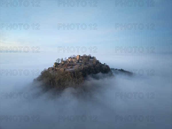 Aerial view of the Hegau volcano Hohentwiel with the upper fortress ruins in front of sunrise,