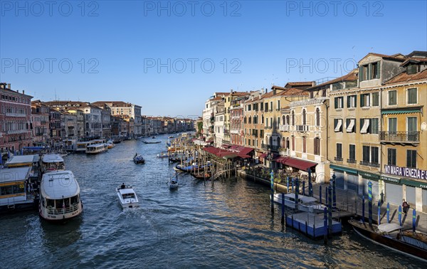 View of the Grand Canal with water taxis and vaporetto in the evening light, view from the Rialto