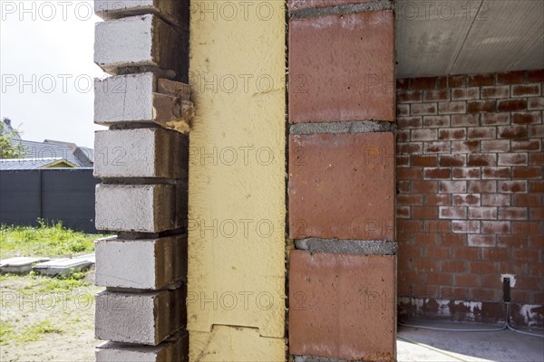 Close up of cavity wall insulation boards fitted in masonry cavities in newly built house used to