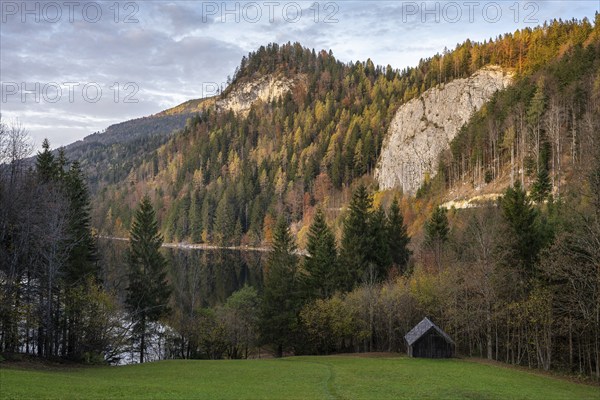 The Schwarzensee and surrounding mountains in autumn. Trees in autumn leaves. Sun and clouds. St.