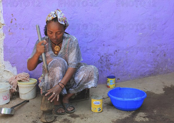 In the highlands of Abyssinia, in the village of Sina, young woman prepares coffee for the coffee
