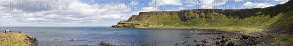 Coastal landscape with cliffs and sweeping sea views under a blue sky, Giant Causeway