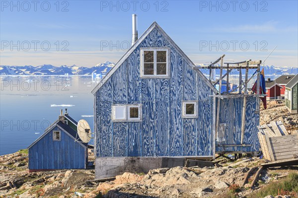 Typical Greenlandic house in an Inuit settlement on a fjord off Bergen, sunny, Ittoqqortoormiit,