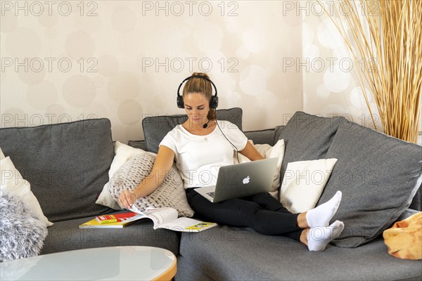 Young student learns at home, online, in conversation with other students