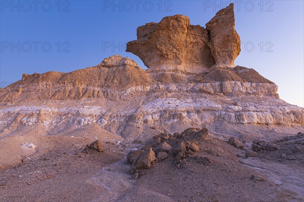 Eroded rock formations on a fossilised reef edge, at blue hour, Huqf stone desert, Arabian