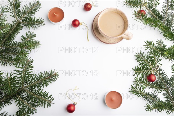 Christmas or New Year frame composition. Decorations, red balls, fir and spruce branches, cup of