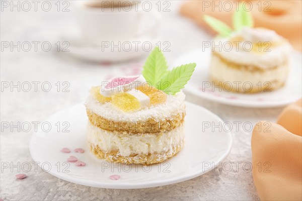 Decorated cake with milk and coconut cream with cup of coffee on a gray concrete background and