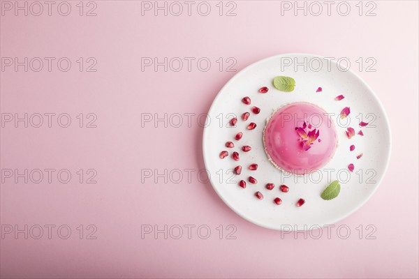 Pink mousse cake with strawberry on a pastel pink background. top view, flat lay, copy space