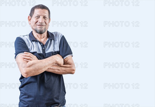 Portrait of smiling senior man with arms crossed isolated. Smiling latin old man with arms crossed,