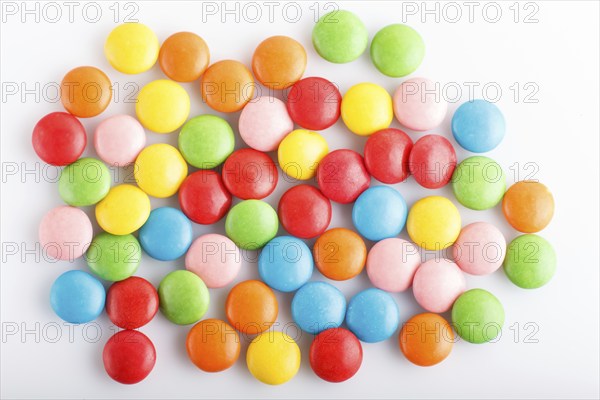 Colorful multicolored chocolate candy dragees isolated on white background. Top view, close up