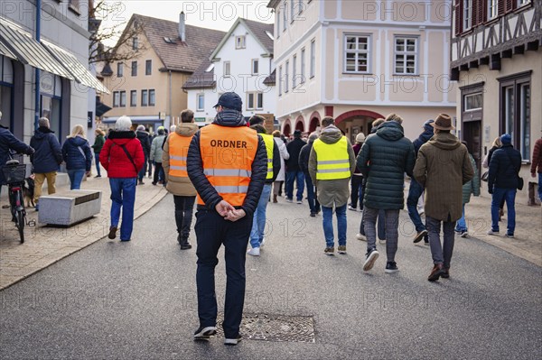 Rear view of an organiser walking through a city street, Gegen Rechts Demo, Nagold, Black Forest,