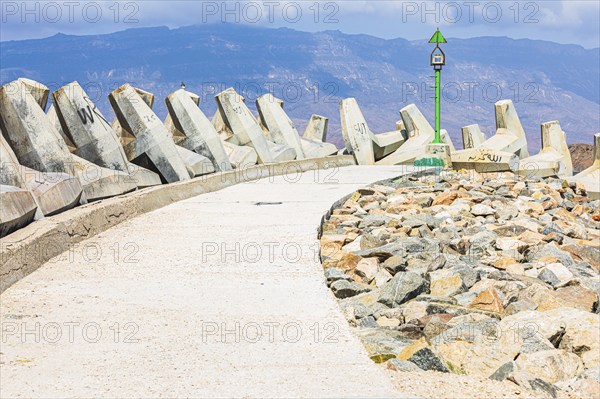 Concrete breakwater with lighthouse in Mirbat harbour, Dhofar province, Arabian Peninsula,