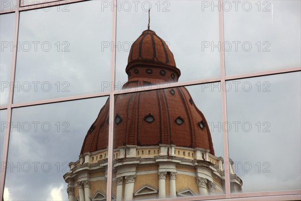 City of Targu Mures, Buna Vestire church, church tower reflected in a glass façade, Romania, Europe