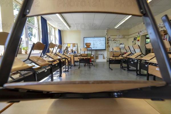 Classroom of a fourth grade, after school, the building is older but in good condition, modern