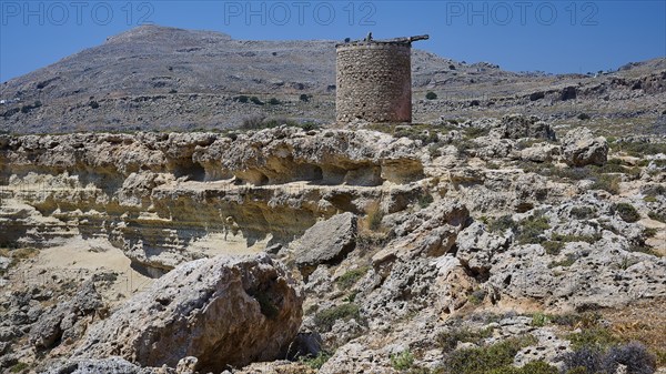 Medieval ruin on a rocky terrain with a clear blue sky, windmill, ruin, near Lindos, Lindos,