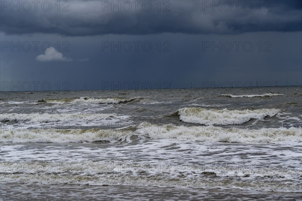 Beach, dark storm clouds, choppy sea, autumn on the North Sea in North Holland, between the towns