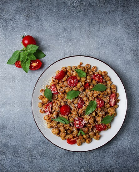 Tuscan pasta with smoked paprika and basil, parmesan cheese, Italian traditional cuisine