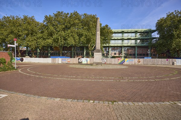 Roundabout with memorial to the fall of the Berlin Wall and the renovation of the town hall in