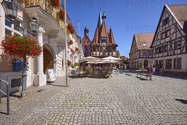 Market square with lantern, outdoor area of a café and historic town hall in Michelstadt, Odenwald,
