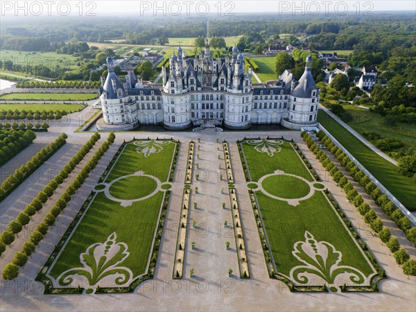 Impressive castle with magnificent symmetrical gardens and Renaissance architecture, seen from the