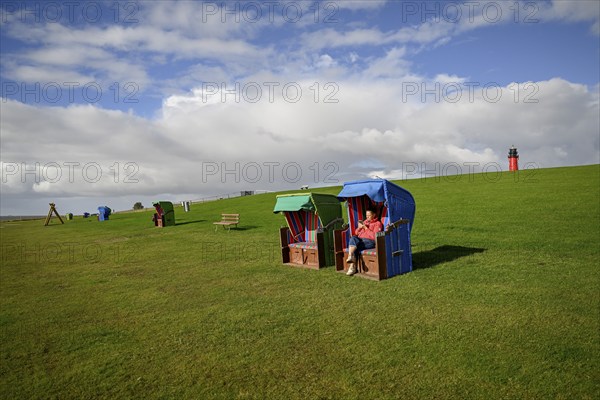 Woman in a beach chair on the island of Pellworm, Wadden Sea National Park, North Frisia, Germany,