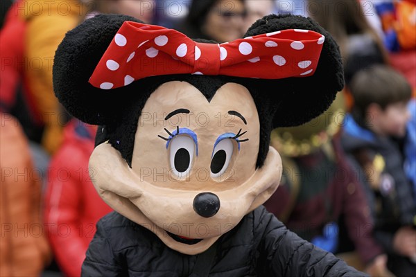 Person masked as Mickey Mouse at the carnival parade of the Wey guild on Rose Monday, Güdismäntig,