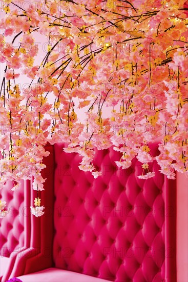 Vintage decoration in pink with plush sofa as furnishing, flowers, interior, design, upholstery,