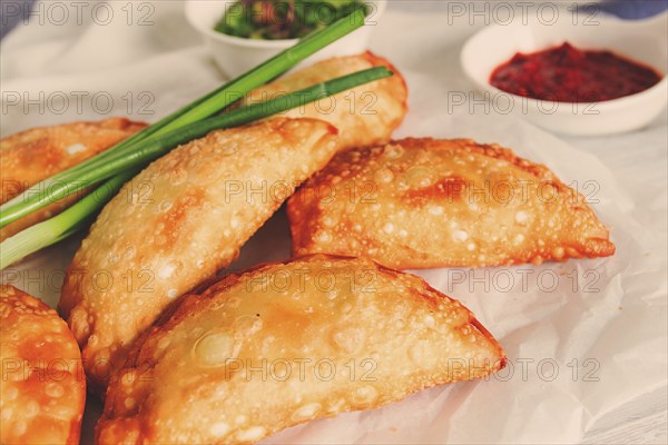 Fried chebureks, close-up, on a light background, no people