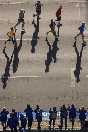 Marathon runners and their shadows at the 50th BMW Berlin Marathon 2024 on 29 September 2024