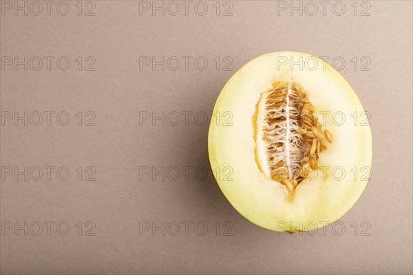 Sliced ripe yellow melon on brown pastel background. Top view, flat lay, copy space. harvest, women