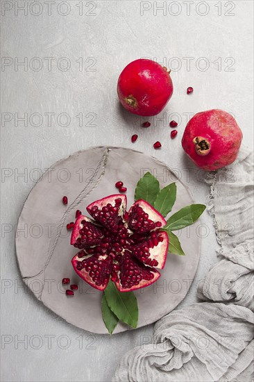 Fresh, cut pomegranate fruit, on a gray background, food concept, top view, no people