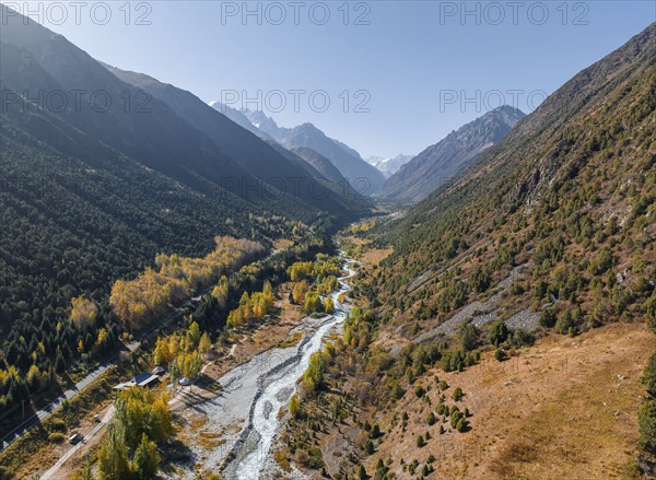 Aerial view, mountain stream Ala Archa flows through the Ala Archa valley, autumnal mountain