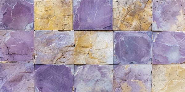 Wall with old square shaped purple and yellow stone cubes. KI generiert, generiert, AI generated