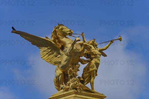 Column with the group of figures Fama of War on the Pont Alexandre III bridge over the Seine,