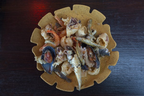 Deep-fried seafood, fritto misto baked on a plate of bread dough, Burano, Venice, Italy, Europe