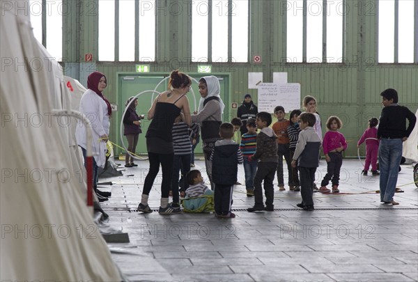 Children of refugees playing between tents in an emergency shelter for refugees on 9 December 2015