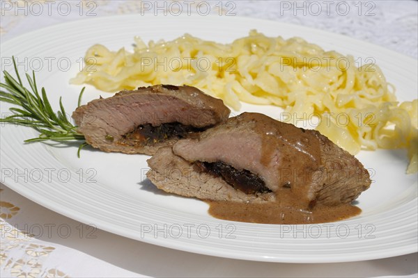 Swabian cuisine, lamb stuffed with prunes, rosemary, herbs, fillets arranged on plates,