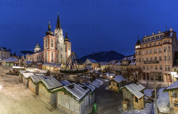 Christmas market in front of the basilica on the main square, blue hour in the early morning,