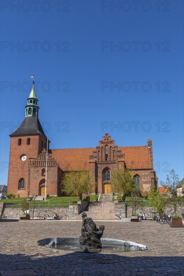 In front of Frue Kirke, Church of Our Lady on the market square, brick building, stepped gable,