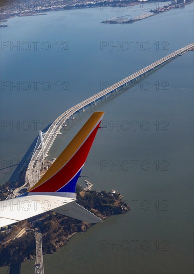 San Francisco, California, A Southwest Airlines plane flies over Yerba Buena Island and the San