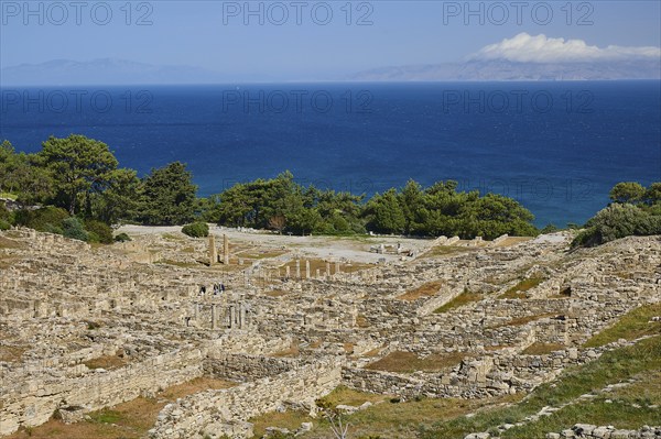 View of the ruins of an ancient historical site by the sea under a cloudy sky, Kamiros,