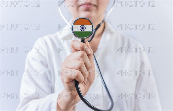 Doctor holding stethoscope with India flag. National Health System of India