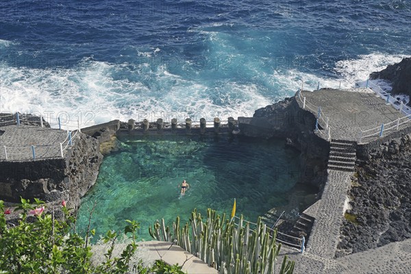 An oceanfront swimming area surrounded by rocks and waves, Charco Azul, San Andres, La Palma,