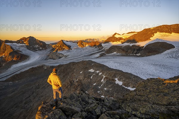 Mountaineer at the summit of the Becher, view of high mountain landscape with glacier