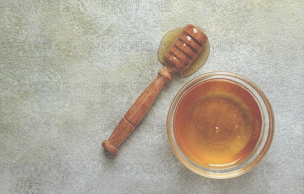 Wooden spoon with honey, on the table, spindle for honey, mace, close-up, rustic