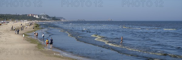 Tourists on the beach, behind the pier of Heringsdorf, Ahlbeck, Usedom Island, Baltic Sea,