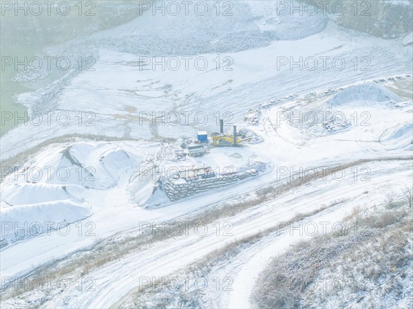 Detailed view of a snow-covered area in a quarry with excavators, Nagold, Black Forest, Germany,