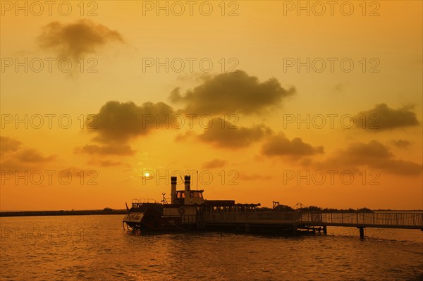 Paddle steamer Tiki III at the jetty at sunset, Les Saintes-Maries-de-la-Mer, Camargue, Provence,