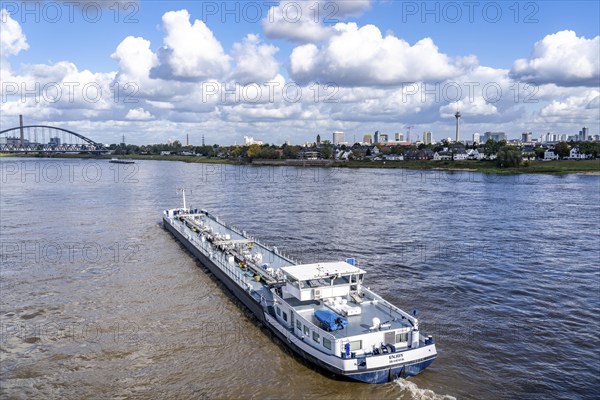 Skyline of Düsseldorf, cargo ship, tanker Enjoy, office tower blocks, residential buildings in