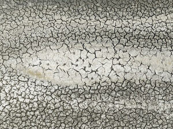 Cracked earth in the marshland near Sanlúcar de Barrameda. Aerial view. Drone shot. Cádiz province,